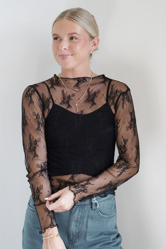 Lucy Sheer Lace Fitted Top Round Lace Neckline Long Sleeve Sheer/ See Through Material Lace Trim Color: Black Waistline Length 100% Polyester