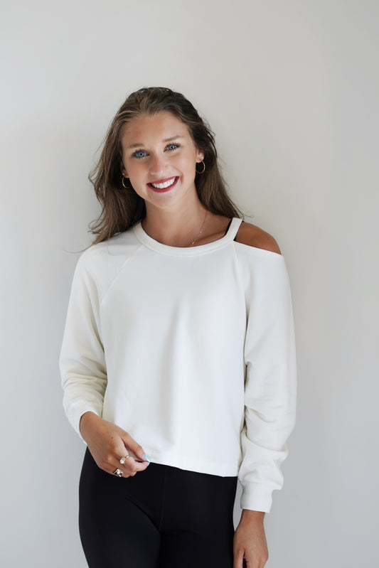Savy Studio Modal Sweatshirt Crew Neckline Long Cuffed Sleeves Open Cold Shoulder Between the Crew Neckline and the Start of the Sleeve Sandstone Color Relaxed Fit Skimmer Length 97% Modal 3% Spandex