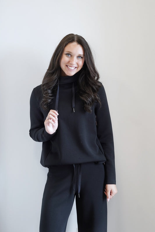 Spanx AirEssentials 'Got-Ya-Covered' Pullover High neck design keeps the cold air out Long Sleeves Colors: Black  Drawstrings at Neckline Full Length Relaxed Fit 47% Modal, 46% Polyester, 7% Elastane