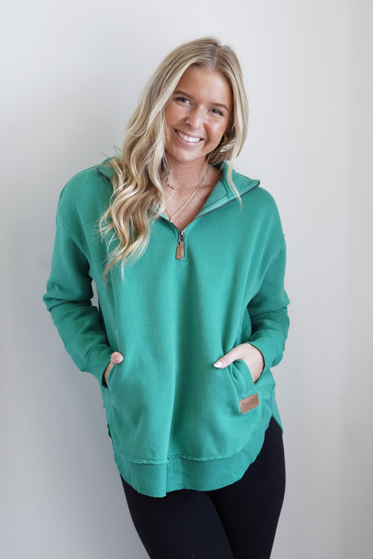 Kenz Quarter Zip Pocket Pullover Collared Zip Up Neckline Long Cuffed Sleeves Front Pockets Ribbed and Raw Hemline Colors: Emerald Full Length Relaxed Fit 58% Polyester, 42% Cotton