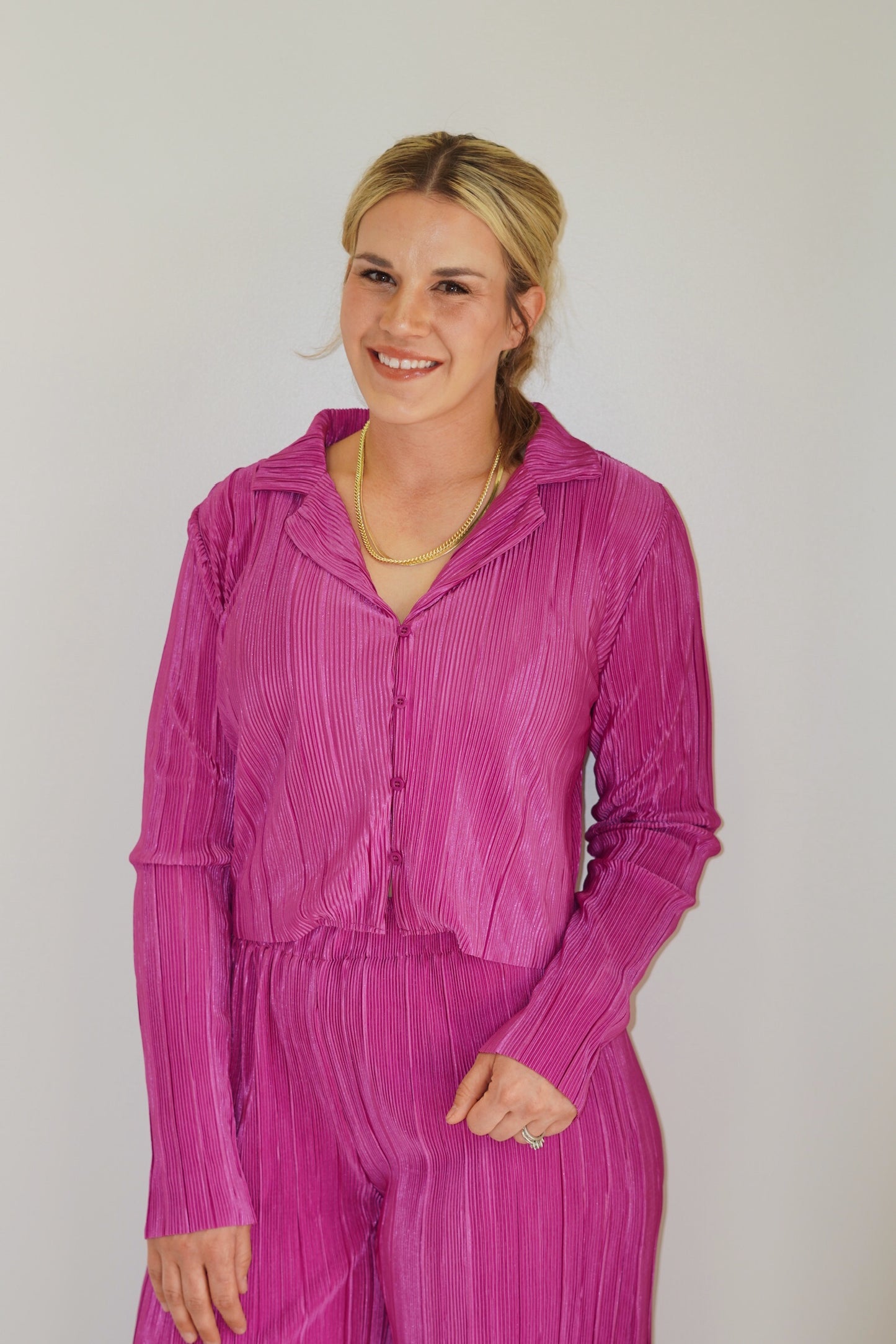 Shelly Cropped Satin Button Up Collar Neck Raw Hem sleeve Pleated material, magenta color Cropped button up 100% Polyester Hand wash cold, do not bleach. Hang or line dry. Model is wearing size large