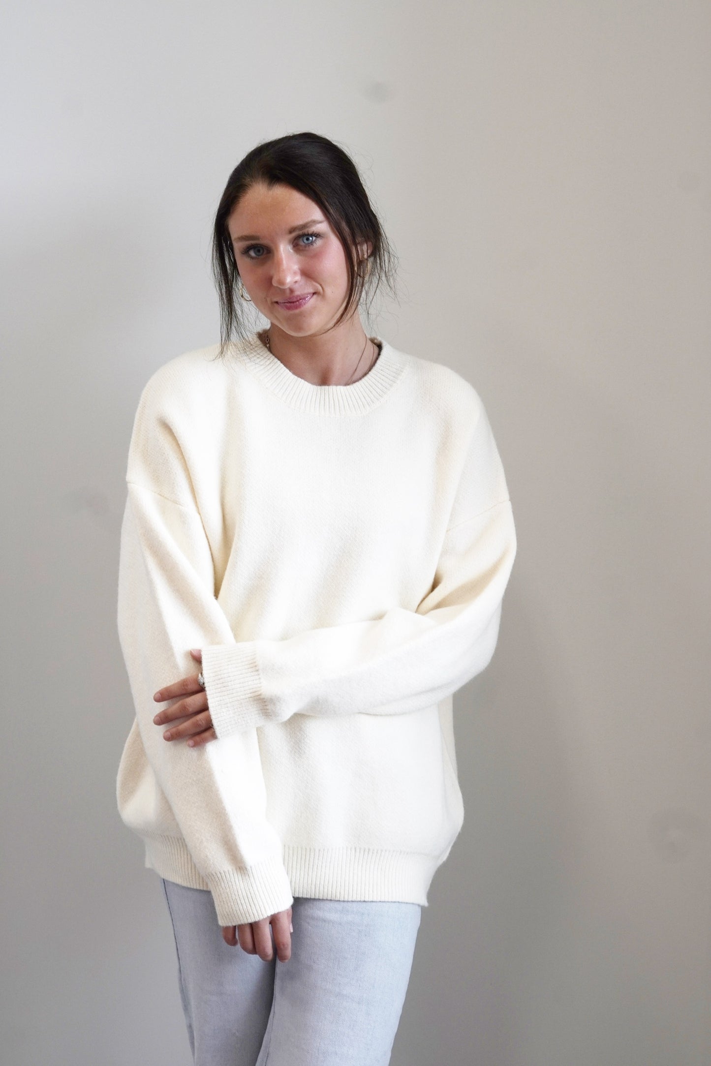 Snuggle Up Crew Sweater Crew Neckline Long Cuffed Sleeves Thick Knit Material Cream Color Relaxed Fit Gathered Knit Bottom Hem Full Length 52% Acrylic, 25% Nylon, 23% Polyester