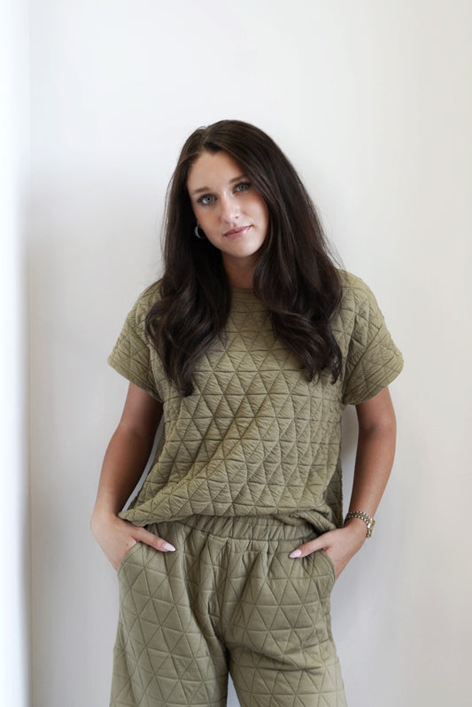 Cozy and Quilted Short Sleeve Top Round Neckline Short Capped Sleeves Quilted Fabric Colors: Olive, Full Length Relaxed Fit 98% Polyester, 2% Spandex