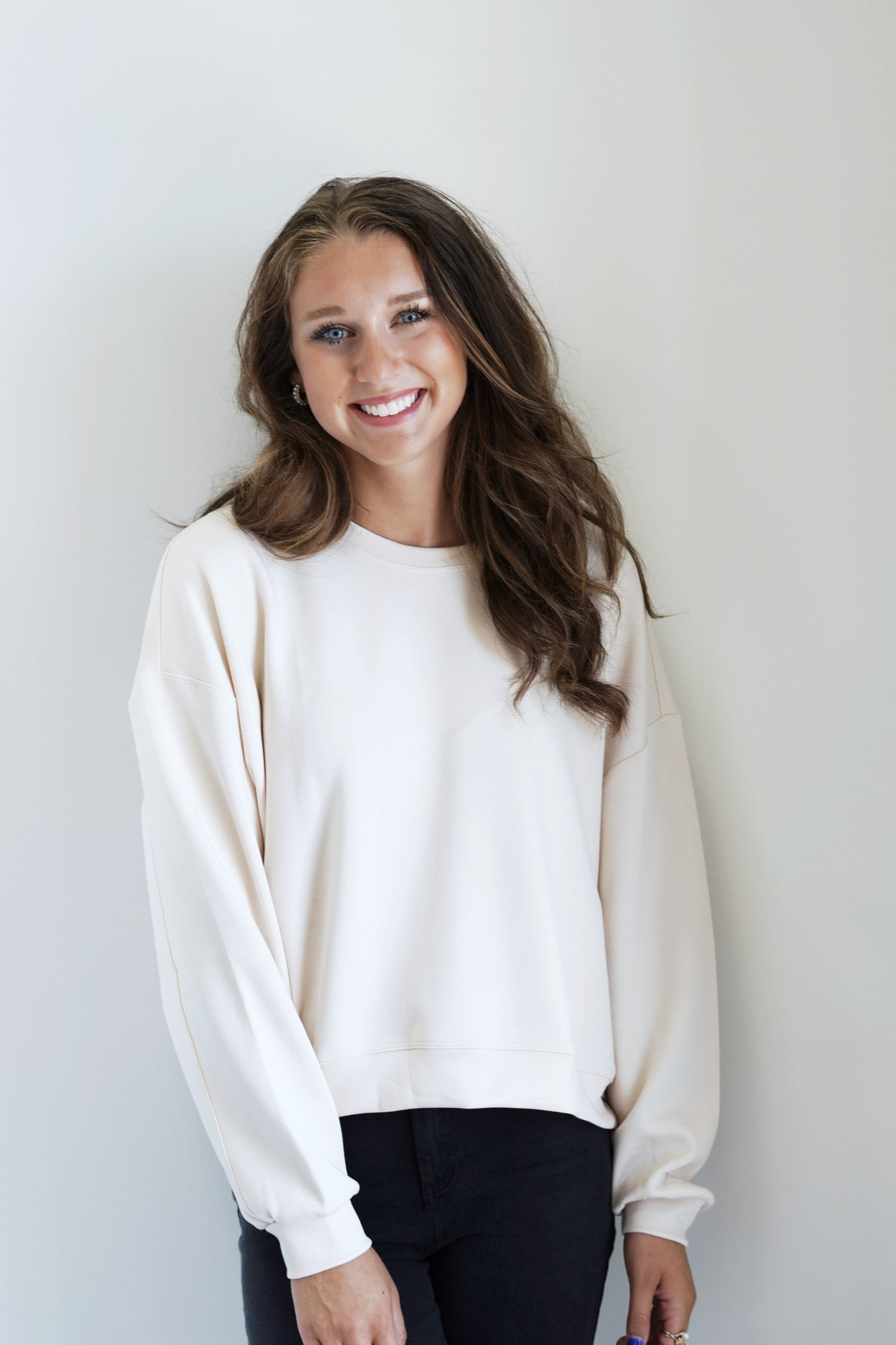 Sully Sleek Relaxed Sweatshirt Crew Neckline Long Cuffed Sleeves Skimmer Length Stretchy Material Relaxed Fit Cream Color 55% Rayon, 40% Polyester, 5% Spandex