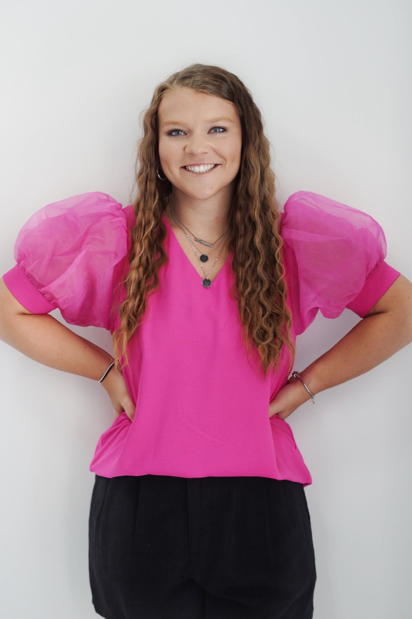 Polly Puffed Sleeve Top V-neck Puffed Sleeve Color: Black and Hot Pink Full Length 100% Polyester Hand Wash Cold, Do Not Wring or Twist, Use Only Non-Chlorine Bleach, Line Dry, Low Iron As Needed, May Be Dry Cleaned Model is wearing a size Small