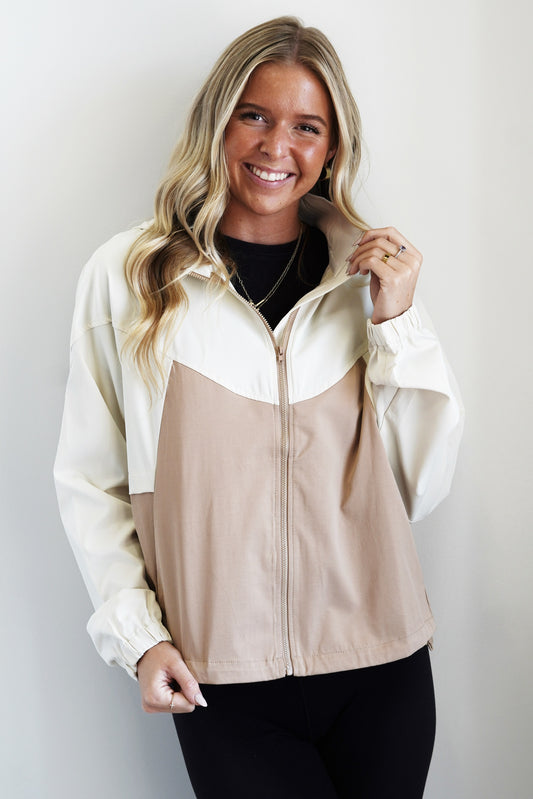 Cray Cream and Mocha Contrast Windbreaker Zip Up Hood Colors: Cream and Mocha Pockets Long Cinched Cuffed Sleeves Full Length Relaxed Fit 100% Polyester