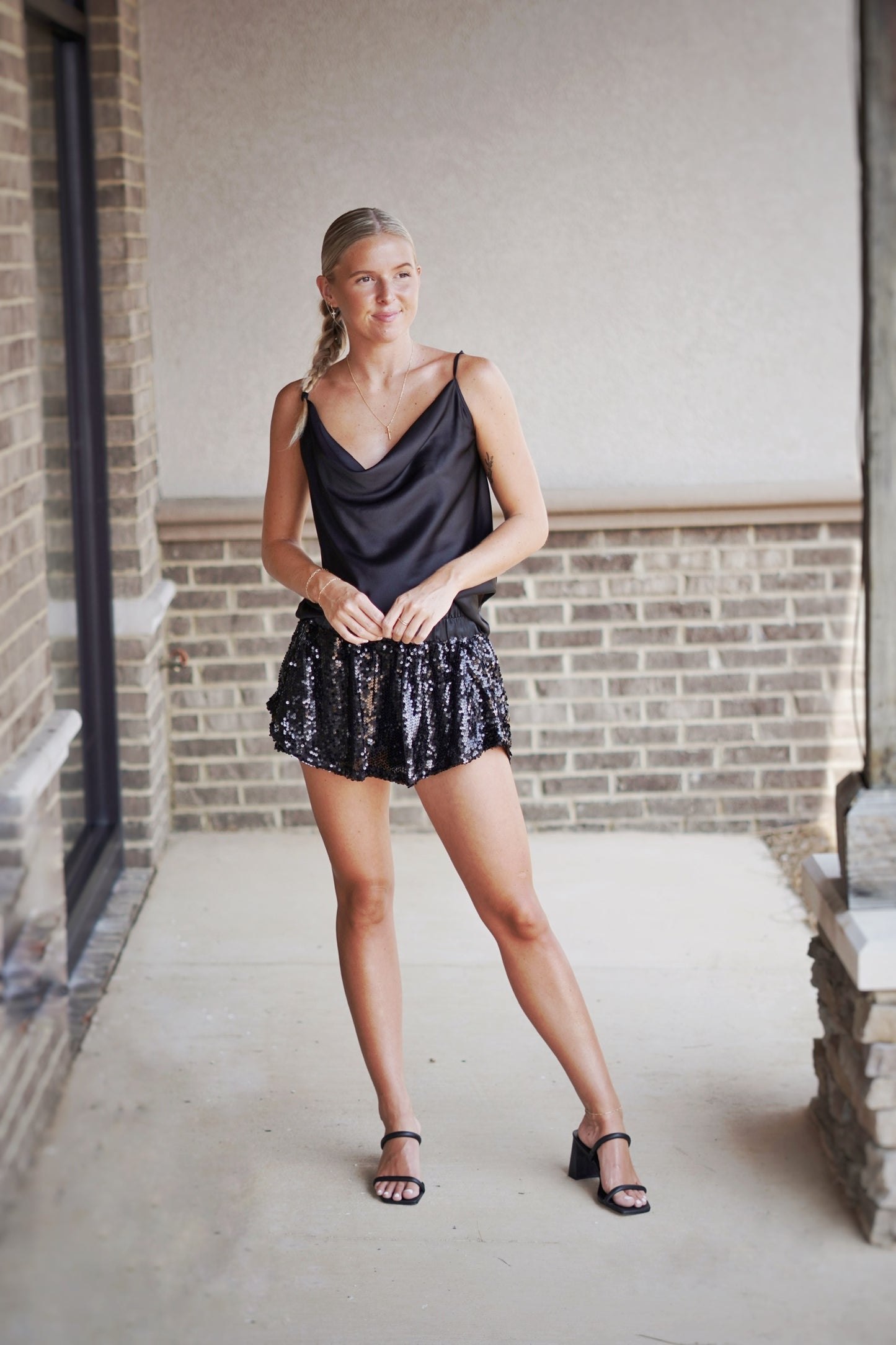Sabrina Sequin High Waisted Skort High Waistline Skirt Layered over Front Black Sequins Slim Fit Waistband/ Loose Fit Shorts 100% Polyester Model is wearing a size small