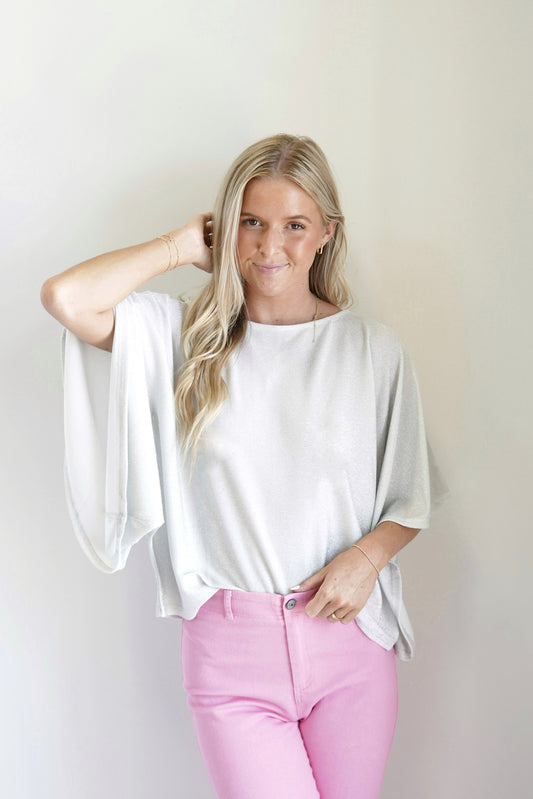 Janet Dreamy Angel Sleeve Top Round Neckline Short Angel Wing Sleeves Sparkly Fabric Silver Color Loose Fit 56% Polyester, 34% Cannetille, 10% Spandex