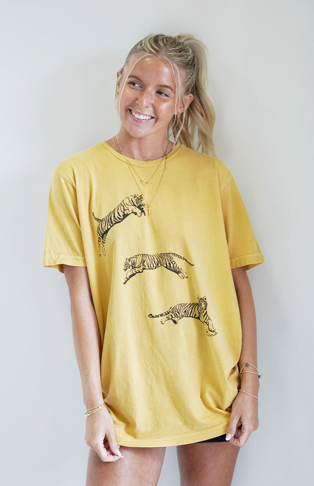 Julie Jumping Tiger Graphic Tee Crew Neckline Short Sleeve Jumping Tiger Feature  Color/Mustard True to size fit 100% Cotton Machine wash warm inside out with like colors. Model is wearing size: medium