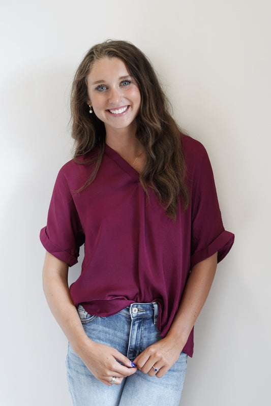 The Priscilla Perfect Sleek Blouse Deep V-Neckline Cuffed Short Sleeves Plum Full Length Relaxed Fit 100% Polyester 
