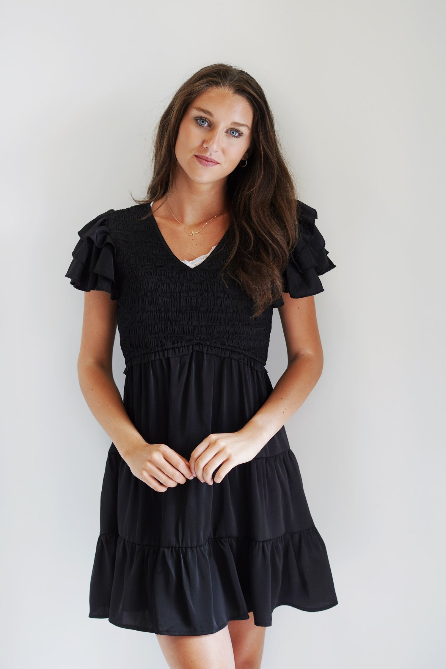 Becca Black Ruffle Sleeve Dress V Neckline Ruffle Sleeves Texture Material on top half of dress Black Satin Material, Knee length 100% Polyester Hand Wash Cold, Use Non Chlorine Bleach, Line Dry Model is wearing a size small