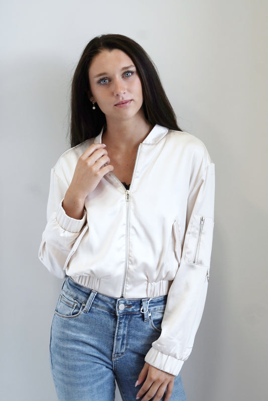Neely Satin Cinched Jacket Zipper Long Cinched at Cuff Sleeves Pockets Pocket on Left Sleeve Cream Satin Color Skimmer Length Relaxed Fit 96% Polyester, 4% Spandex