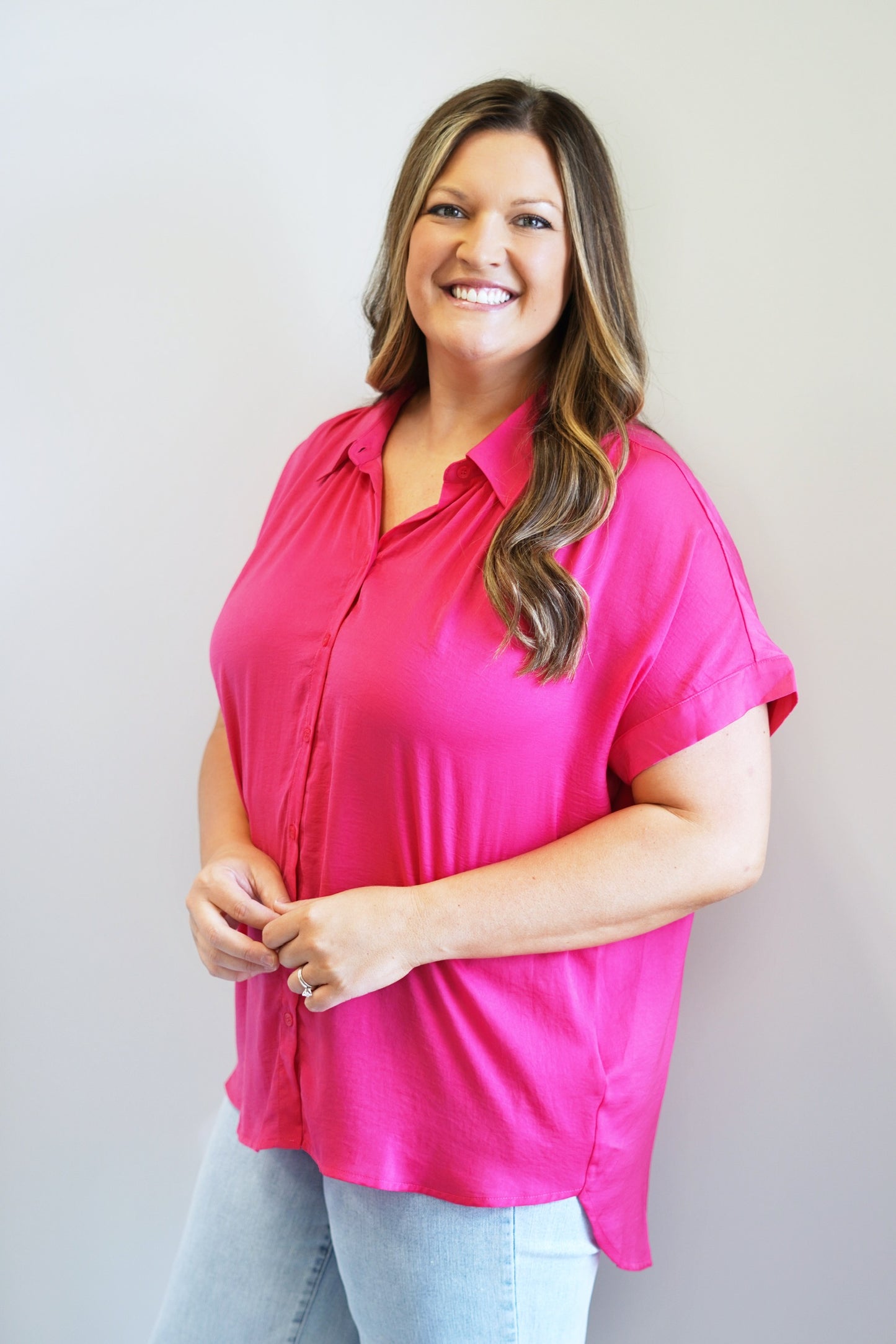 Chasity Button Up Blouse Collared Neckline Button Up Short Cap Sleeves Colors: Emerald and Hot Pink Loose Fit Full Length 100% Polyester Hand Wash Cold, Low Iron as Needed, Line Dry, Do Not Wring or Twist Model is wearing a size 1XL