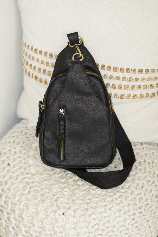  This Nikki Crossbody Backpack is essential this summer! Throw this on leaving the house to run errands or going to a sports event. The perfect colors nude and black will go with any outfit you have on!  8"x13"x2" 2 zipper openings Zipped pocket in the front Braided Zippers Crossbody Strap Black