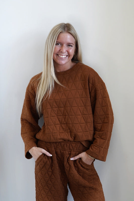 Cozy and Quilted Long Sleeve Top Round Neckline Long Sleeves Quilted Fabric Color: Burnt Orange Skimmer Length Relaxed Fit 98% Polyester, 2% Spandex