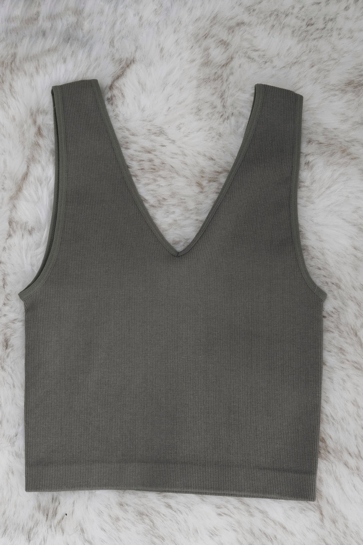 Beautiful basic Cropped Tank V-Neckline Sleeveless Ribbed Material Colors:  Olive, Fitted Cropped 72% Modal, 24% Nylon, 4% Spandex