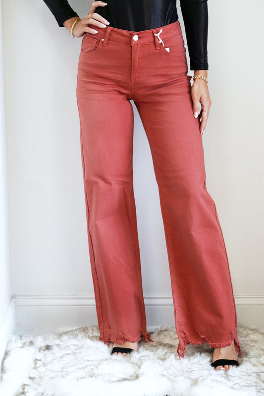 Remy High Rise Rust Wide Leg Jeans Belt Loops around Waistline Button/Zipper Closure Wide Leg Jeans Color: Rust Full Length Fit Pockets on Front and Back of Jeans Raw Hem