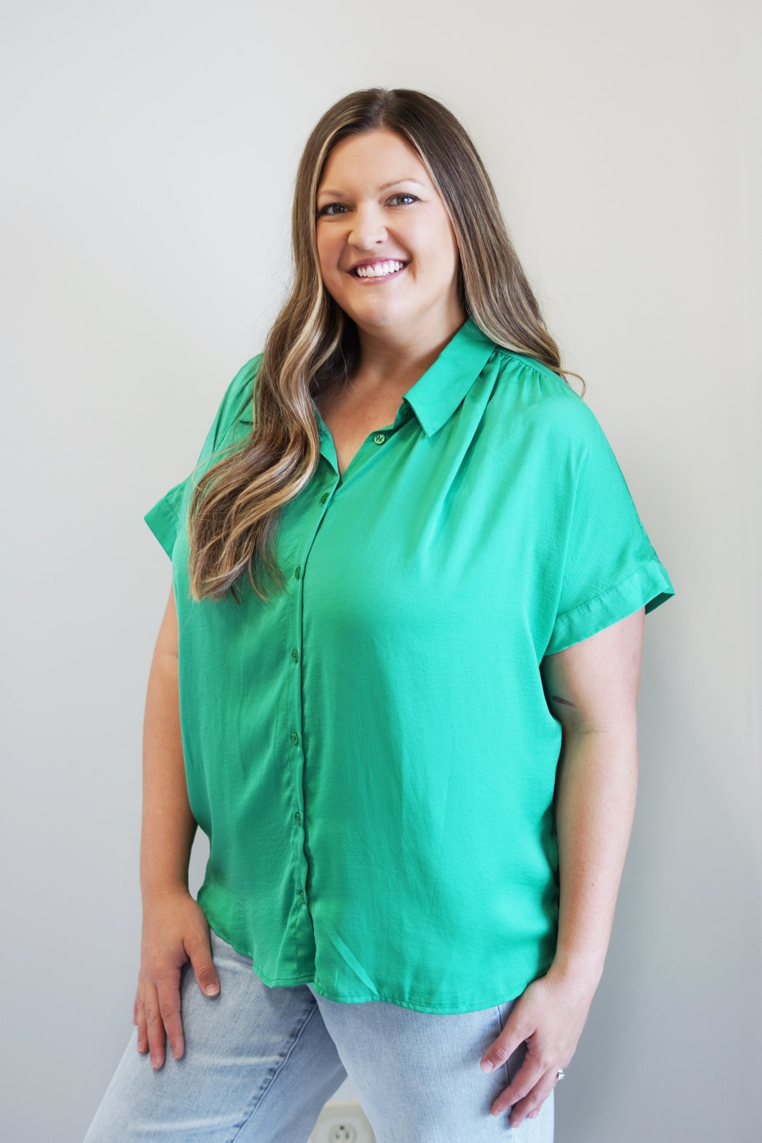 Chasity Button Up Blouse Collared Neckline Button Up Short Cap Sleeves Colors: Emerald and Hot Pink Loose Fit Full Length 100% Polyester Hand Wash Cold, Low Iron as Needed, Line Dry, Do Not Wring or Twist Model is wearing a size 1XL